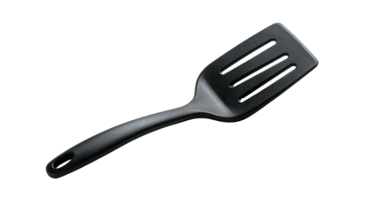 A close-up of a black slotted spatula on a black background, angled view