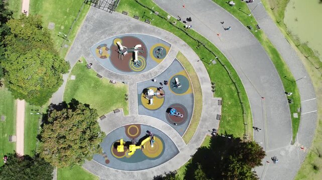 Top view Simon Bolivar natural park kids zone playground green area forest zone sunny day buildings background Bogota Colombia