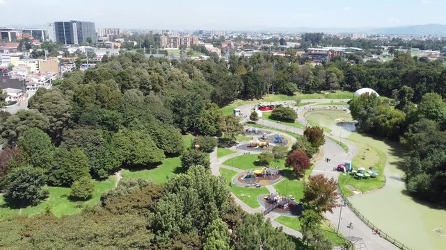 Aerial view Simon Bolivar natural park kids zone playground green area forest zone sunny day buildings background Bogota Colombia.