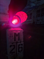 Railway traffic light with red signal. Railroad traffic light at night