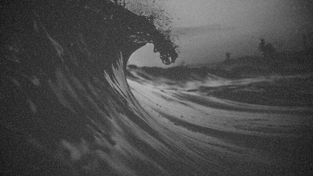 Black and white photo of surfing wave with grunge texture.