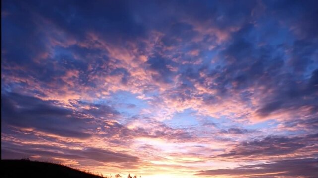 A breathtaking celestial display unfolds across the expansive sky, showcasing a dynamic interplay of vibrant clouds. The scene is bathed in a magnificent palette of deep blues, rich purples, warm oran