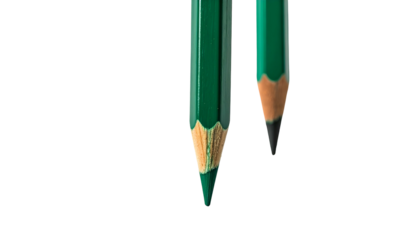 Two sharpened green pencils against a stark black background, showcasing their tips