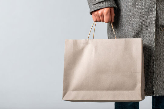 White canvas tote bag carried outdoors, ideal for branding, advertising, eco friendly campaigns, reusable shopping concepts, and product mockup presentations with clean copy space.
