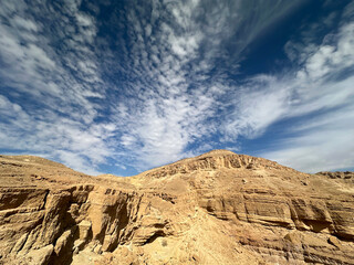 Eilat Mountains desert landscape with layered sedimentary cliffs and dramatic sky