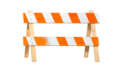 A road construction sawhorse barricade, orange and white striped, wooden supports, against black
