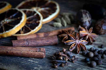 Traditional Christmas aromatic spices, dry oranges, cinnamon stick, anis, nutmeg, glove, pepper, cardamom. Ingredients for mulled wine. Aesthetic Christmas scent still life