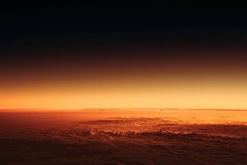 Fiery horizon over cloudscape at twilight