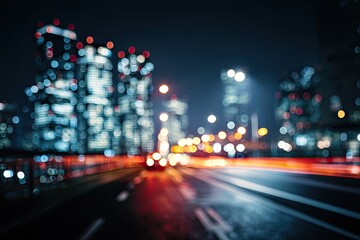 Blurred city lights and streaks of car headlights on a wet road at night