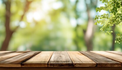 Empty wooden table foreground with blurred green foliage background