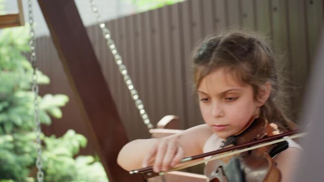 Young Girl Practicing, Caucasian Girl Diligently Refining Her Skills In Calm Garden Environment, Serene Garden Setting Where Young Woman Carefully Improves Her Bowing Technique With Concentration
