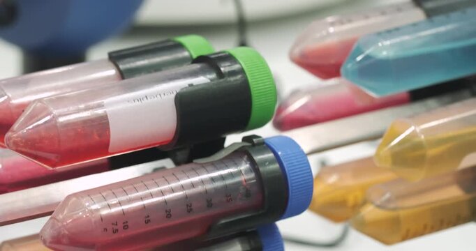 Glass vials ampoules liquid mixed on device in medical laboratory, medical analysis concept