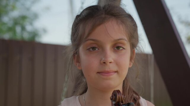 Bright Northern Child Joyful With Violin, Young Girl Joyfully Playing Violin Beneath Warm Northern Sunlight, Girl From Northern Region Smiling Brightly While Holding Her Violin With Pride
