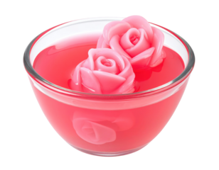 Two Pink Rose-Shaped Desserts Floating in a Glass Bowl of Liquid
