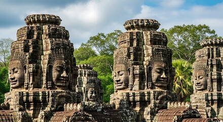 Ancient stone towers feature multiple serene carved faces amidst lush tropical foliage