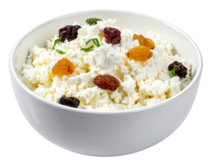 Cottage cheese with colorful raisins and fresh mint leaves in a white bowl