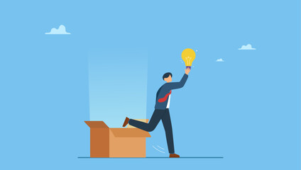 Smart businessman get out of paper box with new lightbulb idea. Think outside the box, creativity to create different business idea or motivation and innovation.
