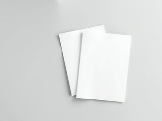 Two blank white paper cards or envelopes on a light gray background