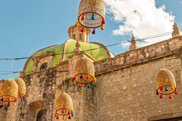 Colonial church dome and hanging wicker lanterns with colorful tassels in historic center of Morelia, Mexico