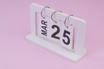 March 25 on calendar on pink background	