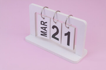 March 21 on calendar on pink background	