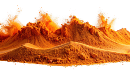Mountains of orange powder erupt in a splash against a black background