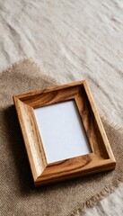 Close-Up Shot of Empty Wooden Photo Frame on Natural Fabric Background for Greeting Card Concept