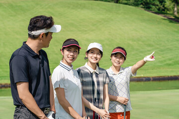 Male and female golfers enjoying golf at the golf course