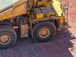Fototapeta premium Mining trucks in the process of transporting minerals from an open pit mine to a processing plant