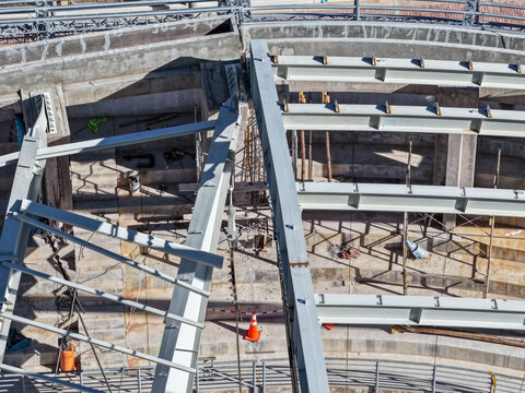 Aerial view of a coliseum with a collapsed metal structure and undergoing structural inspections