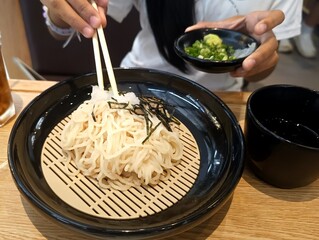 woman holding a bowl of noodles