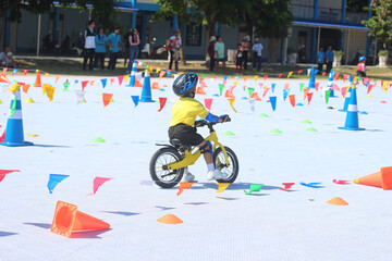 The children are having a race on balance bikes.