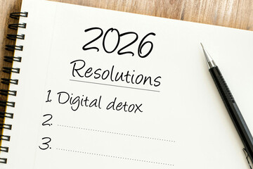 Handwritten 2026 Resolutions list in a spiral notebook with Digital detox as the first goal and a pen on the side.