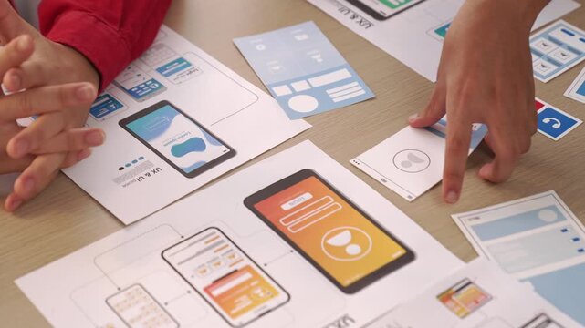 Panorama video of startup company employee planning on user interface prototype for mobile application or website in office. UX UI designer brainstorm designing user friendly interface plan. Synergic