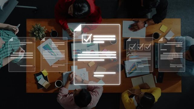 A dynamic overhead view of a vibrant team engaged in a brainstorming session, utilizing digital tools and collaborating effectively in a modern office setting. Raster