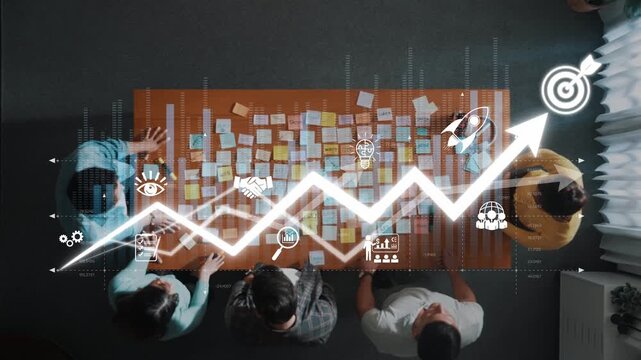 A group of professionals collaborates in an office environment, using sticky notes and visual graphs to analyze and strategize progress towards their goals. Raster