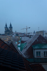 Fototapeta premium Peaceful rooftop outlook with spires, Calm elevated scene overlooking gothic towers and snow, Silent high place with distant gothic spires and snowy rooftops observing urban quietude
