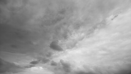 Dark stormy landscape, Dramatic weather scene with swirling dark clouds gathering overhead, Cinematic scene featuring turbulent sky with breaking light and ominous storm clouds