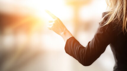 Woman Using Smartphone Outdoors in Bright Sunlight with Long Wavy Hair and Black Jacket