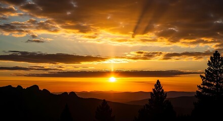 Dramatic Golden Sunset Over Silhouetted Mountain Range with Fiery Sky and Sun Rays.