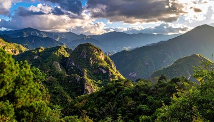 Naklejka premium Verdant Mountain Range Under Dramatic Sky - A Scenic Landscape.