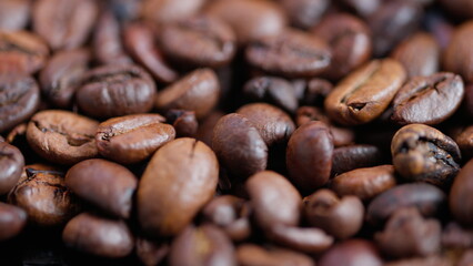 Fototapeta premium Coffee bean closeup, Detailed shot of aromatic brown coffee beans with subtle oil, Highquality depiction of aromatic roasted coffee beans with appealing gloss and warm hues
