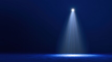 Dramatic Spotlight Illuminating a Dark Stage with Soft Blue Light Creating a Mystical Atmosphere Perfect for Background or Theatrical Themes