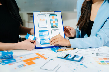 UX developer and ui designer brainstorming about mobile app interface wireframe design with customer breif and color code