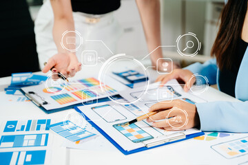 Close up view of UI developer team brainstorming on their project with laptop, smartphone and digital tablet. Creative digital development agency.