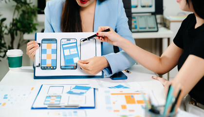 UX developer and ui designer brainstorming about mobile app interface wireframe design with customer breif and color code