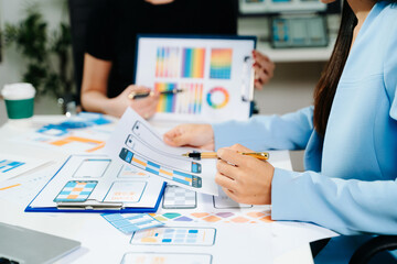 Close up view of UI developer team brainstorming on their project with laptop, smartphone and digital tablet. Creative digital development agency.