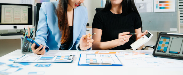 UX developer and ui designer brainstorming about mobile app interface wireframe design with customer breif and color code