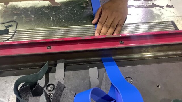 view of  industrial machine is in the process of skiving on leather