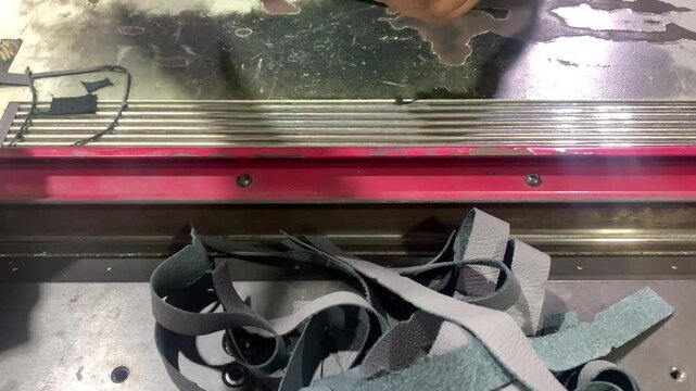view of  industrial machine is in the process of skiving on leather